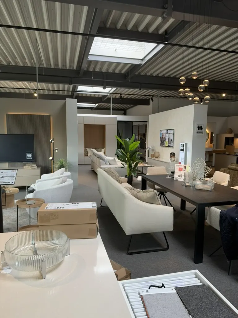 Ausgestellte Sofas, Sessel und Esstisch im Einrichtungsstudio